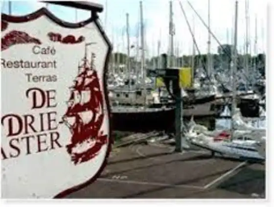 Bord Driemaster met haven op de achtergrond